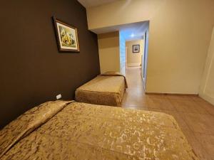 Postel nebo postele na pokoji v ubytování Hotel El Brujo Centro Histórico