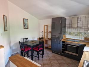 a kitchen with a table and a dining room at Sea View Terrace Apartment Izola in Izola