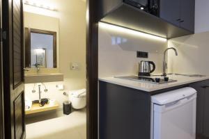 a bathroom with a sink and a toilet at AEGEAN Apartments - Bungalows in Alacati