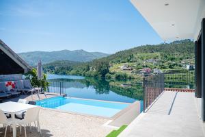 a balcony with a view of a lake at Lajinha do Ave in Azevedos