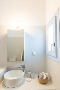 a white bathroom with a sink and a mirror at Light Blue House - Kato Kleisma in Káto Klísma