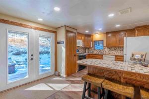 a kitchen with a counter top and a refrigerator at Prairie Creek Cabin w/Hot tub in Rapid City