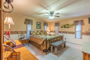 a bedroom with a bed and a ceiling fan at Prairie Creek Cabin w/Hot tub in Rapid City