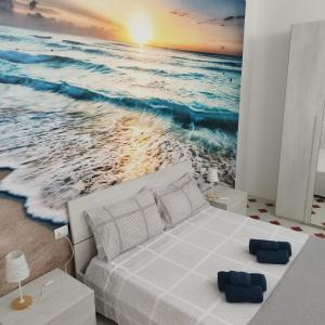 Postel nebo postele na pokoji v ubytování Nuovo bilocale a 100 mt dal mare