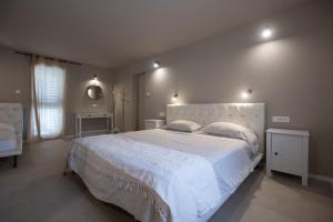 a bedroom with a large white bed with two pillows at Holiday Home LI-ZA in Privlaka
