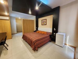 Postel nebo postele na pokoji v ubytování Hotel El Brujo Centro Histórico