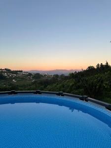 a swimming pool with a view of the sunset at Vila Teixeira in Amarante