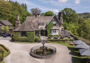 an estate with a fountain in front of a house at Broadoaks Boutique Country House in Windermere