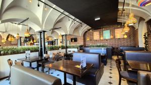 a restaurant with tables and chairs and a brick wall at Main Square Apartments in Krakow +129 photos