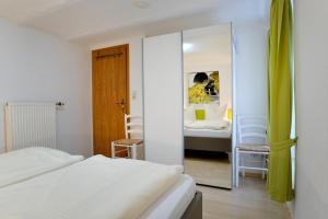 a bedroom with two beds and a mirror at Ferienwohnungen by Weingut Hommes in Ernst Mosel in Ernst