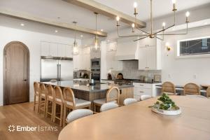 a kitchen and dining room with a table and chairs at Laguna Matata at Desert Color (by Ember Stays) in St. George