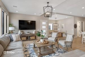 a living room with a couch and a table at The Solace at Desert Color by Ember Stays in St. George
