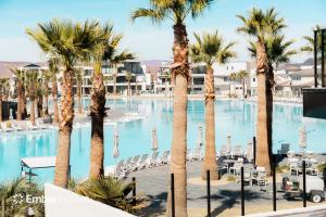 a resort with palm trees and a swimming pool at The Solace at Desert Color by Ember Stays in St. George