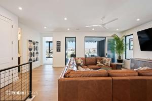 a living room with a couch and a tv at Baseball Beach House at Desert Color (by Ember Stays) in St. George