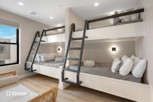 two bunk beds in a room with a window at The Solace at Desert Color by Ember Stays in St. George +31 photos