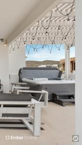 a patio with a pool table and some chairs at The Solace at Desert Color by Ember Stays in St. George