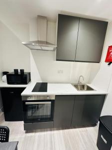 a small kitchen with a sink and a stove at Studio in Oval London in Bellaghy +4 photos