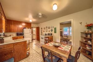 a kitchen with a wooden table and a dining room at Das Mueller Haus in Fredericksburg