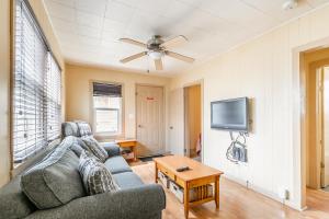 a living room with a couch and a flat screen tv at Bayside Cottage Rentals in Port Rowan