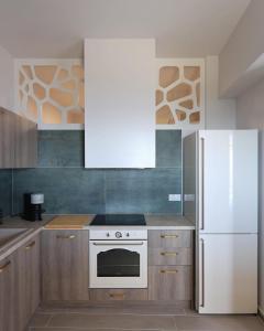 a kitchen with a stove and a refrigerator at Captain's Pounda Suite in Apróvaton