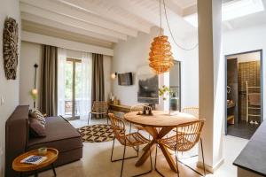 a living room with a table and a couch at Funtukaki by the Pool in Leptokarya