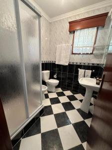 a bathroom with two toilets and a shower at Vila Teixeira in Amarante