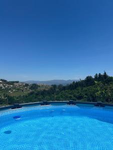 a swimming pool with a view of a mountain at Vila Teixeira in Amarante