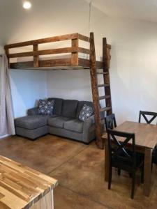 a living room with a couch and a bunk bed at Gold Valley Camp Cabin 3 in Custer