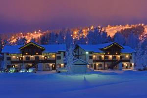 a large building in the snow at night at Apartments Anna in Tahkovuori +32 photos