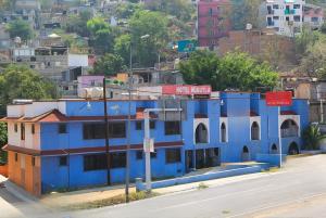a blue building sitting on the side of a street at Hotel Huautla de Oaxaca in Oaxaca City +13 photos
