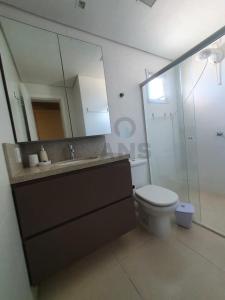 a bathroom with a sink and a toilet and a mirror at ANSNEGOCIOS APTO CHARMOSO PRAIA MARISCAL 101 Italy in Canto Grande +5 photos