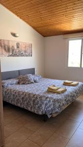 a bedroom with a bed with two towels on it at CA LIDIA -Allotjament Rural ELCAMPANAR in Benimantell