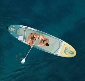 a dog is in a boat in the water at Premium Apartments Punta Kolova in Opatija