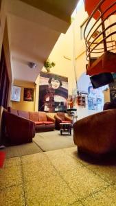 a living room with couches and chairs in a room at Hostal La Realeza in Potosí