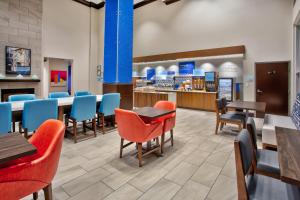 a restaurant with tables and chairs and a cafeteria at Holiday Inn Express Augusta North by IHG in Augusta