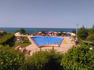 a large swimming pool with people sitting around it at Chilling 32 in San Vito Chietino