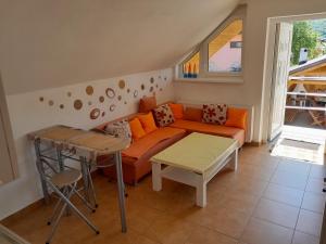 a living room with a couch and a table at Penzión Anika in Krásnohorská Dlhá Lúka
