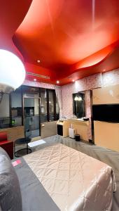 万里区にあるGiyoche Motelのベッドルーム1室(オレンジ色の天井の大型ベッド1台付)