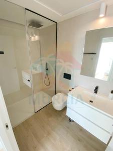 a white bathroom with a shower and a sink at Limonero16 in Orihuela Costa