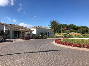 a brick driveway in front of a house with flowers at Limonero16 in Orihuela Costa