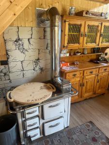 a kitchen with a stove with a counter top at Baita Lomasona in Comano Terme