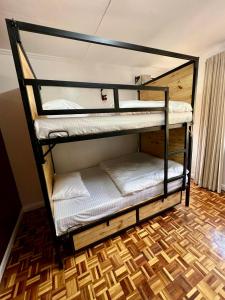 A bed or beds in a room at The Library Hostel