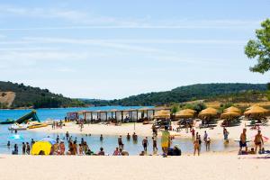 a group of people on a beach with umbrellas at Casa de Campo - Vila Boa in Vila Boa
