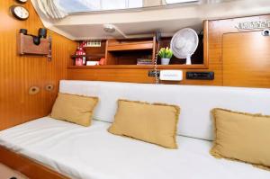 a couch in the back of a boat with two pillows at The Happy Sailor in Viana do Castelo