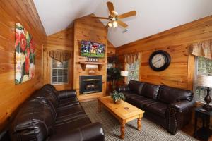 a living room with a couch and a fireplace at Apple Blossom by Eden Crest in Pigeon Forge