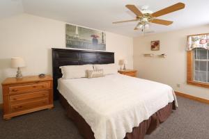 a bedroom with a bed and a ceiling fan at Apple Blossom by Eden Crest in Pigeon Forge