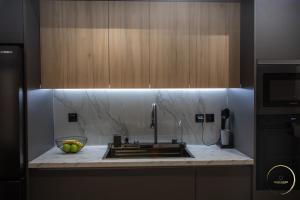 a kitchen with a sink and a counter top at Sunset Shores Mola Kaliva in Mola Kalyva