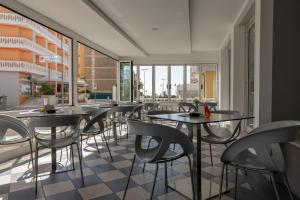 a row of tables and chairs in a restaurant at Hotel Bristol in Caorle