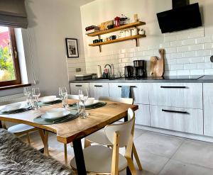 a dining room with a wooden table and chairs at Pod Kasztanem in Zwardoń