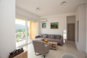 a living room with a couch and a table at Boka Panoramic in Đenovići +15 photos